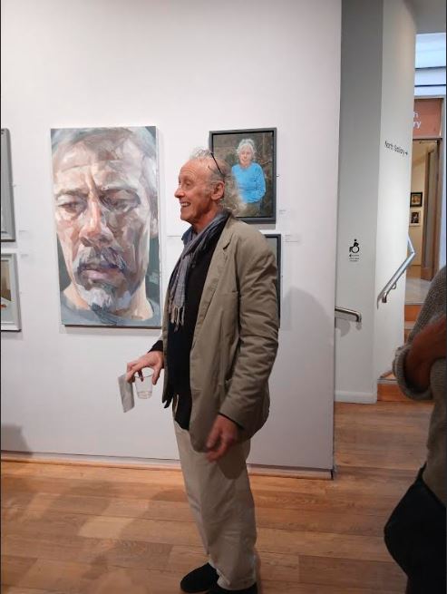 Anthony in front of big portrait